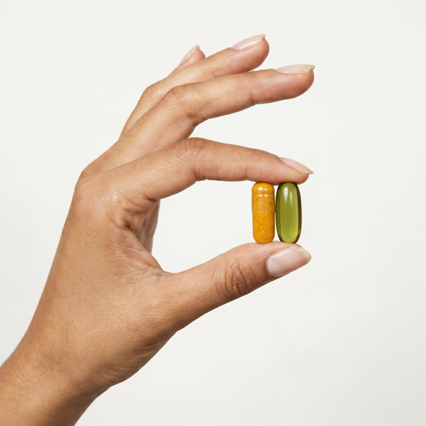 TheraJoint+ and Hempseed Oil capsules held in hand
